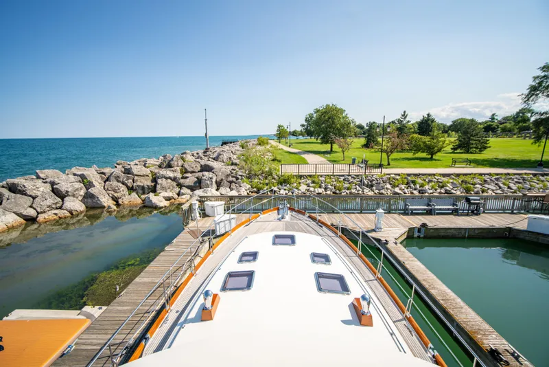 Slide: The Image of Grand Banks 58 Eastbay FB 2004 yacht docked by a scenic waterfront park. - 7