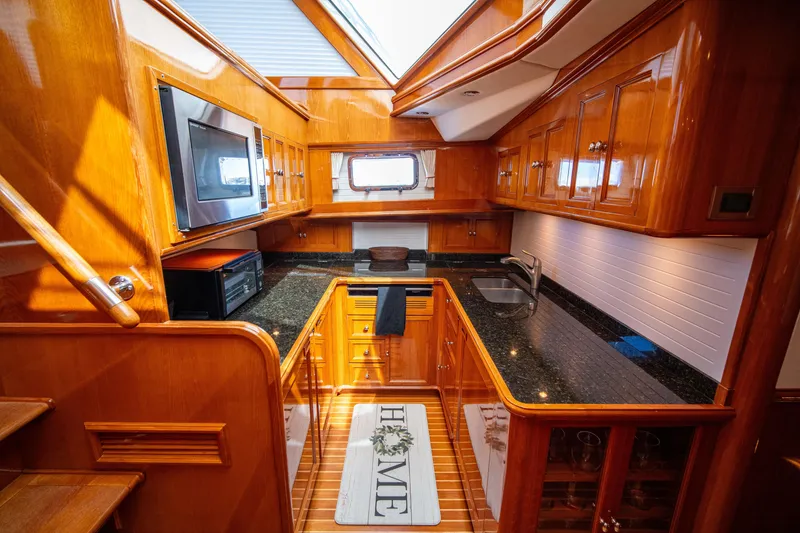 Slide: The Image of Luxurious kitchen interior of 2004 Grand Banks 58 Eastbay FB yacht with wood cabinetry. - 36