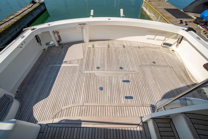 Slide: The Image of Grand Banks 58 Eastbay FB 2004 yacht deck with teak flooring at marina. - 12