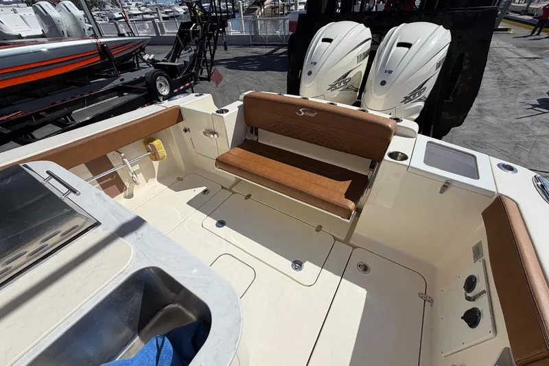 Slide: The Image of 2021 Scout 330 LXF boat interior with seating and dual Yamaha engines. - 13