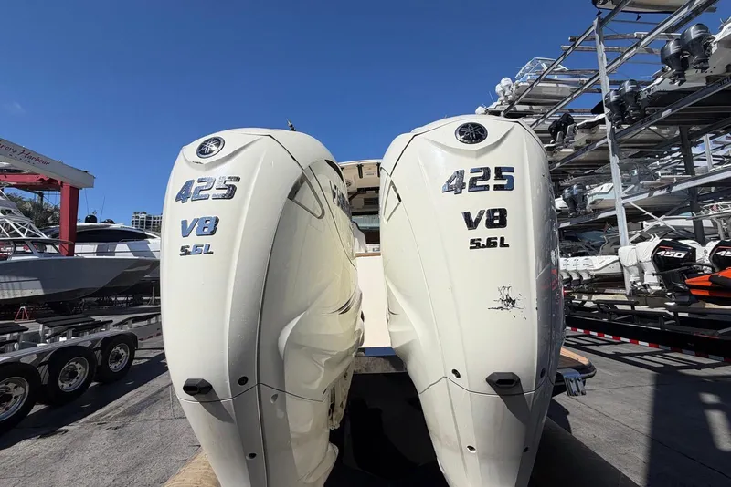 Slide: The Image of 2021 Scout 330 LXF with twin 425 V8 5.6L engines at a marina. - 14