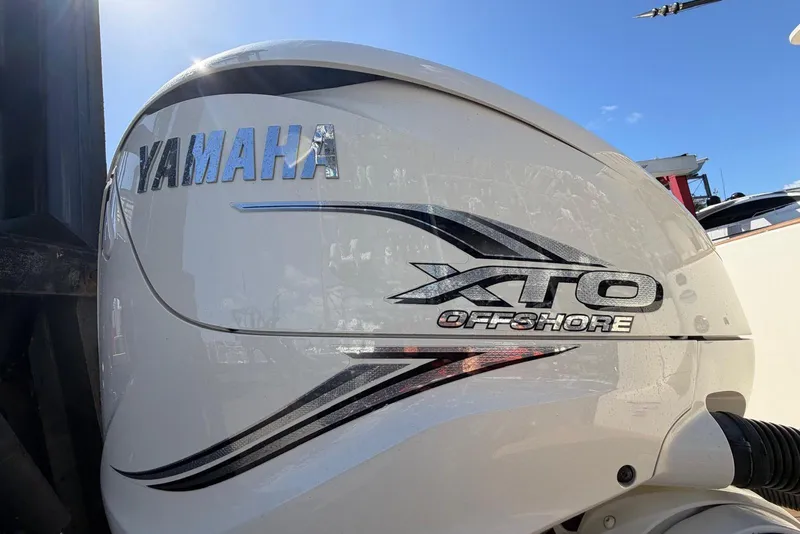 Slide: The Image of Yamaha XTO Offshore engine on 2021 Scout 330 LXF boat under clear blue sky. - 15