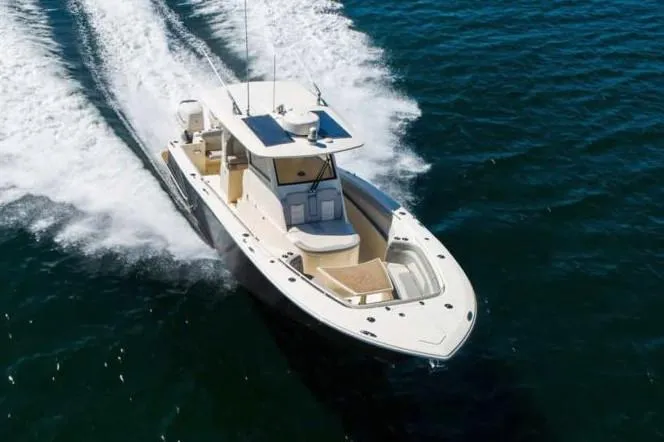 Slide: The Image of Manufacturer Provided Image: 2021 Scout 330 LXF boat cruising on open water. - 26