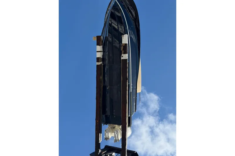 Slide: The Image of 2021 Scout 330 LXF boat on lift against clear blue sky. - 4