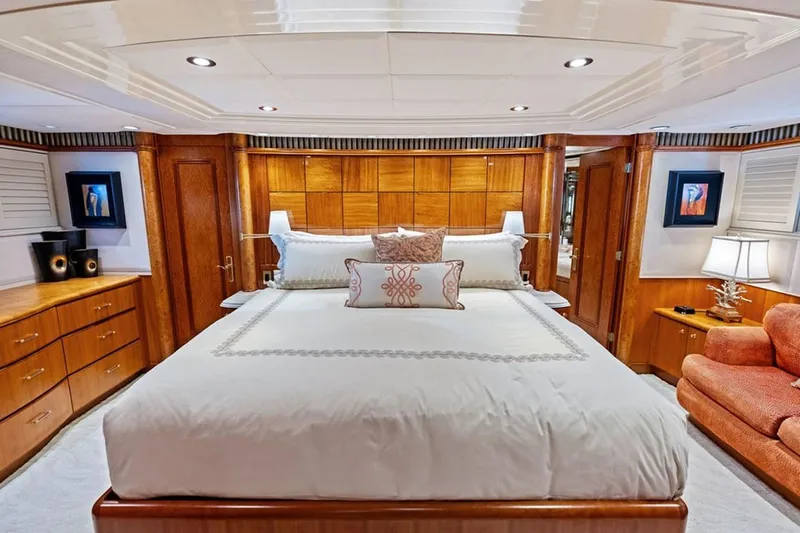 Slide: The Image of Luxurious bedroom interior of 2001 West Bay Sonship yacht with elegant wood paneling and plush bedding. - 10