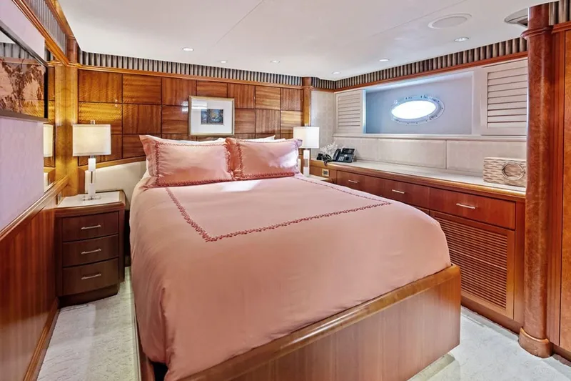 Slide: The Image of Luxurious 2001 West Bay Sonship yacht bedroom with elegant wood paneling and soft lighting. - 15