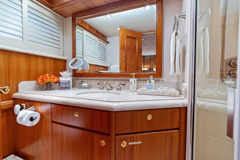 Slide: The Image of Luxurious bathroom in 2001 West Bay Sonship yacht with elegant wood cabinetry and modern fixtures. - 16