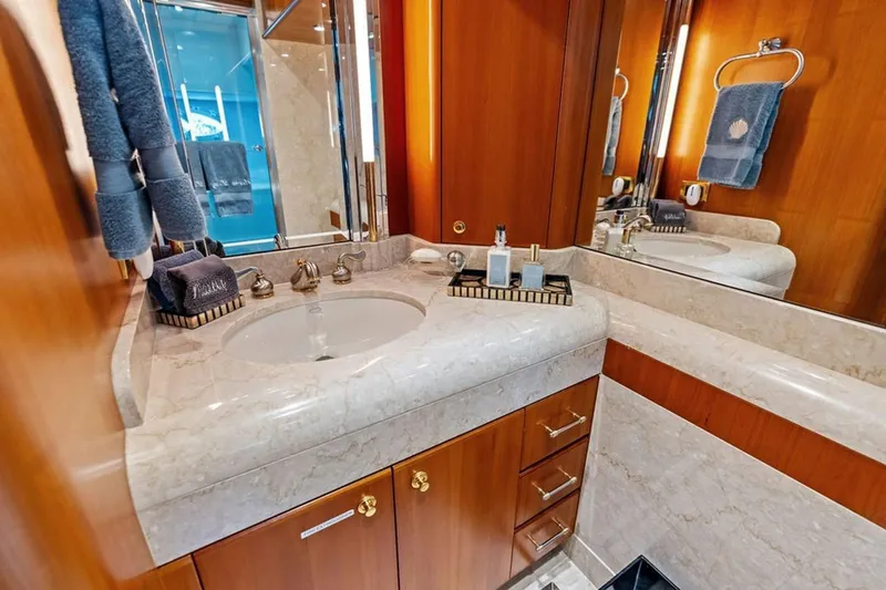 Slide: The Image of Luxurious bathroom in 2001 West Bay Sonship yacht with marble countertop and elegant fixtures. - 18