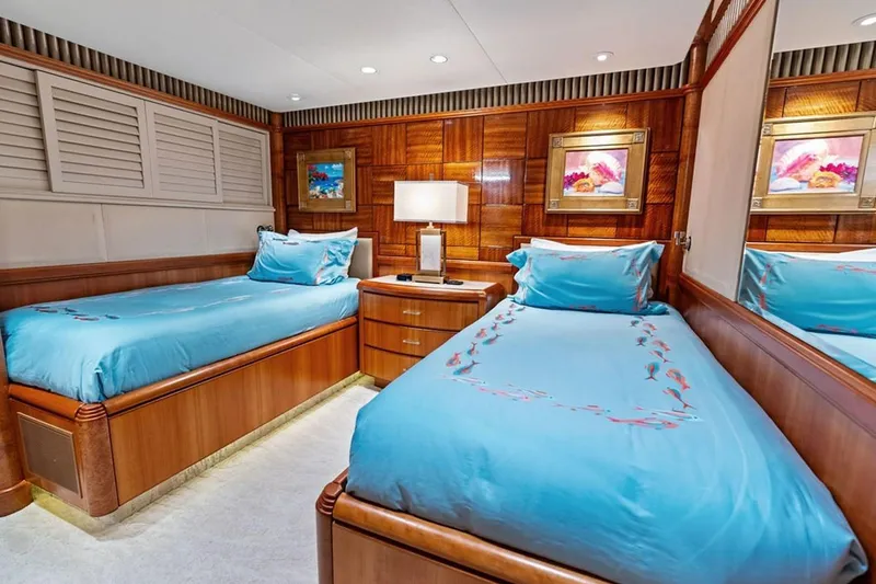 Slide: The Image of Luxurious 2001 West Bay Sonship yacht bedroom with twin beds and elegant wood paneling. - 19