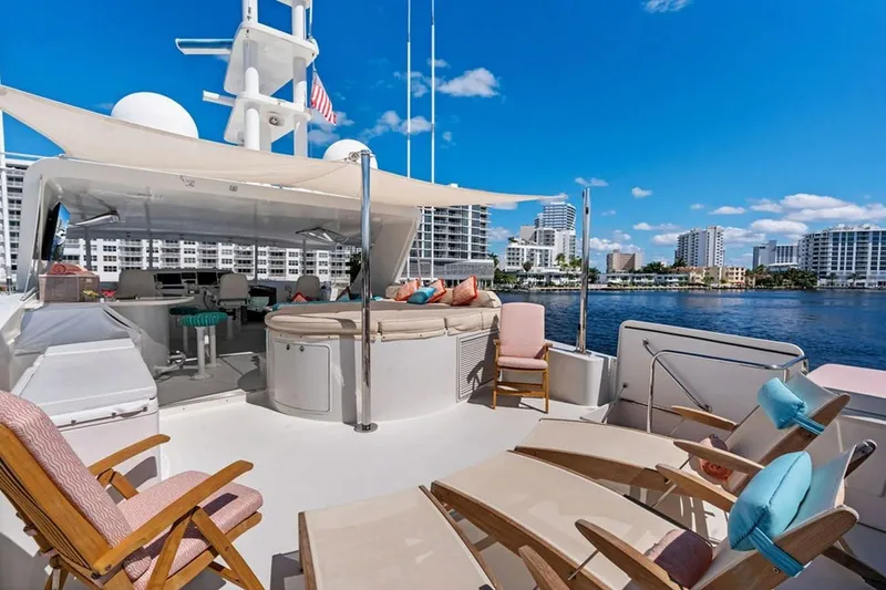 Slide: The Image of Luxurious 2001 West Bay Sonship yacht deck with seating, overlooking waterfront cityscape. - 21