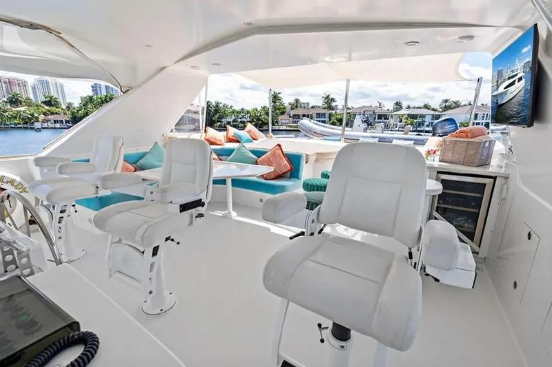 Slide: The Image of Luxurious 2001 West Bay Sonship yacht interior with white seating and waterfront view. - 25