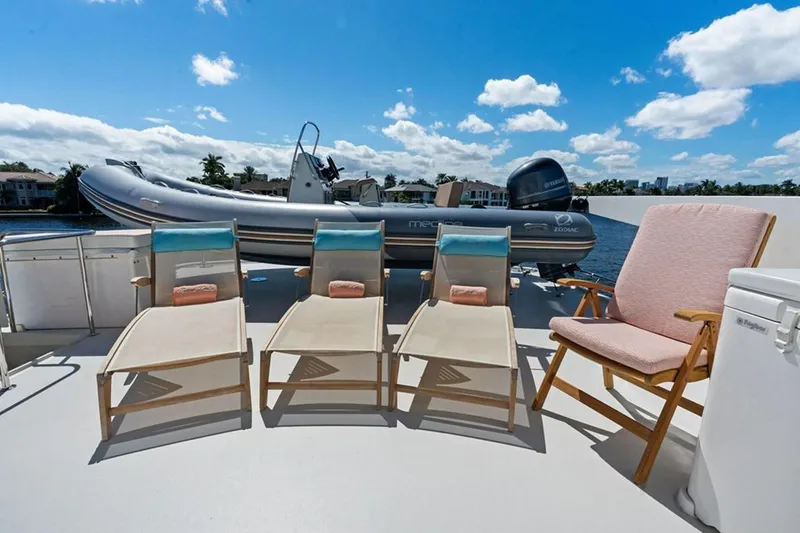 Slide: The Image of Deck of 2001 West Bay Sonship yacht with lounge chairs and inflatable boat. - 27