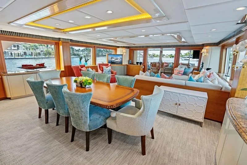 Slide: The Image of Luxurious 2001 West Bay Sonship yacht interior with elegant dining and seating area, waterfront view. - 4