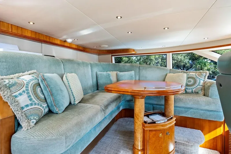 Slide: The Image of Luxurious 2001 West Bay Sonship yacht interior with plush seating and elegant wooden table. - 8