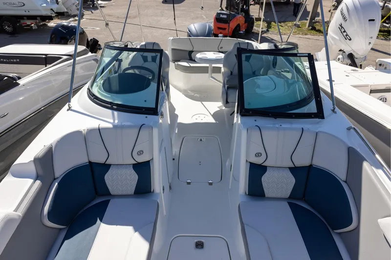 Slide: The Image of 2023 Hurricane SunDeck 2400 OB boat interior with stylish seating and dual windshields. - 15