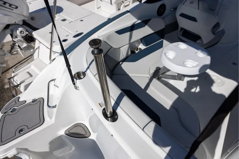 Slide: The Image of 2023 Hurricane SunDeck 2400 OB boat interior with seating and cup holders. - 16