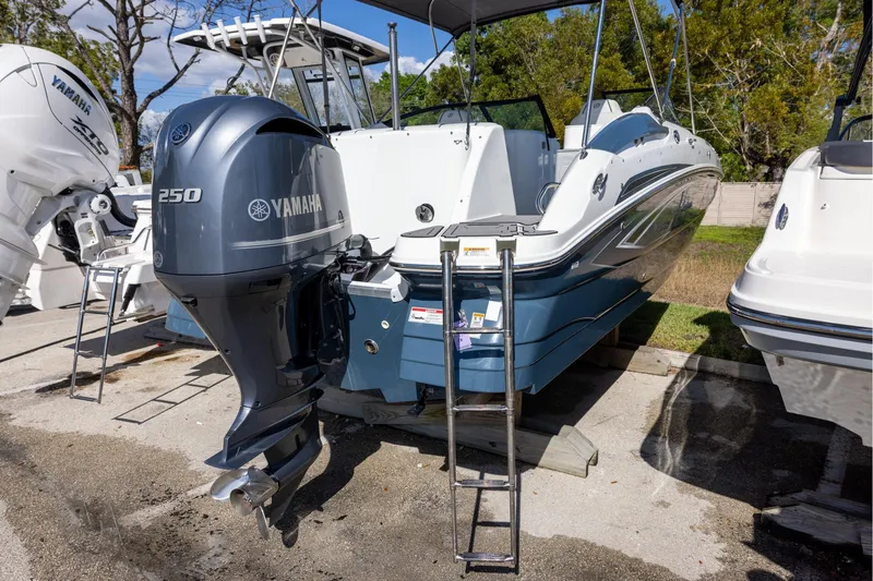 Slide: The Image of 2023 Hurricane SunDeck 2400 OB boat with Yamaha 250 outboard motor, docked outdoors. - 3