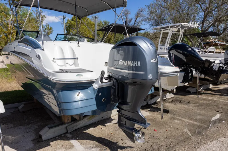 Slide: The Image of 2023 Hurricane SunDeck 2400 OB boat with Yamaha 250 outboard motor, parked outdoors. - 4
