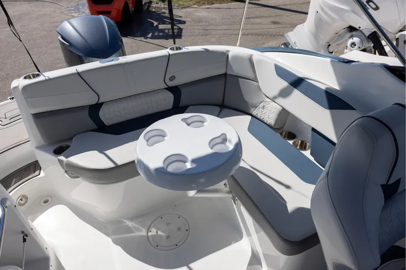 Slide: The Image of 2023 Hurricane SunDeck 2400 OB boat interior with cushioned seating and round table. - 6