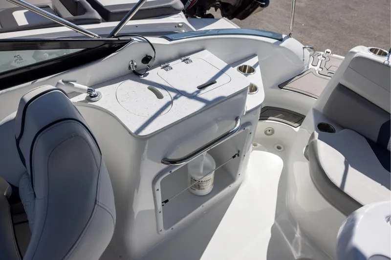 Slide: The Image of 2023 Hurricane SunDeck 2400 OB boat interior with seating and storage area. - 7