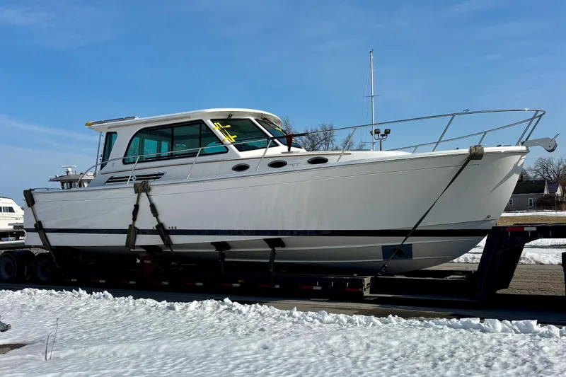 Slide: The Image of 2026 Back Cove 372 boat on trailer in snowy landscape, side view. - 1