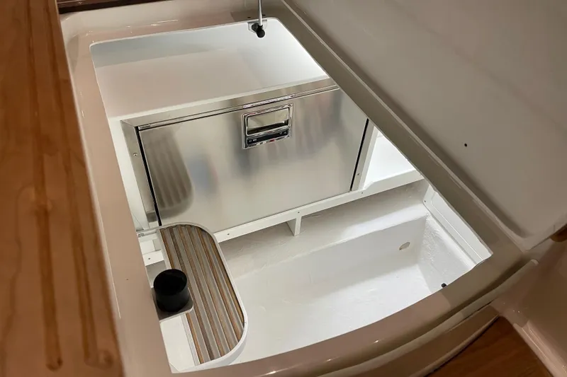 Slide: The Image of 2026 Back Cove 372 boat interior storage compartment with stainless steel features. - 12