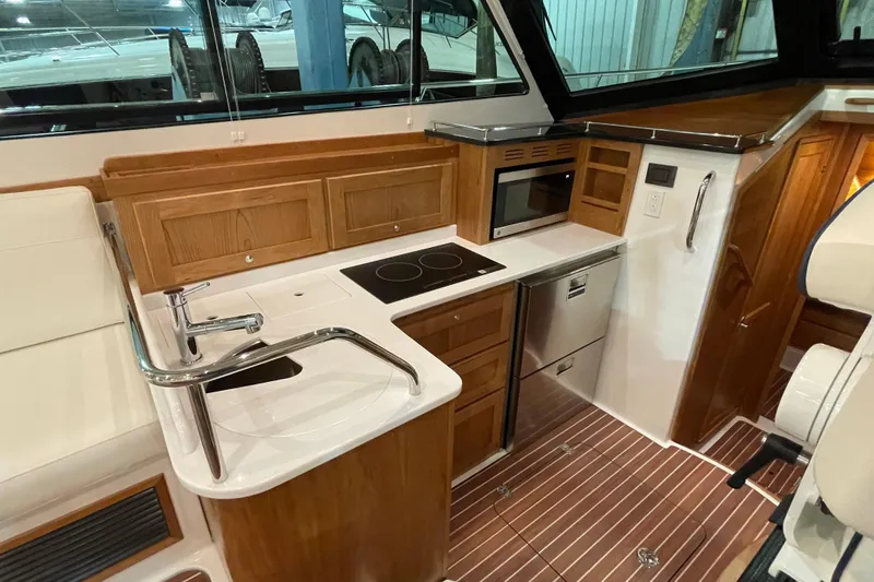 Slide: The Image of Luxurious 2026 Back Cove 372 yacht kitchen with modern appliances and elegant wood cabinetry. - 13