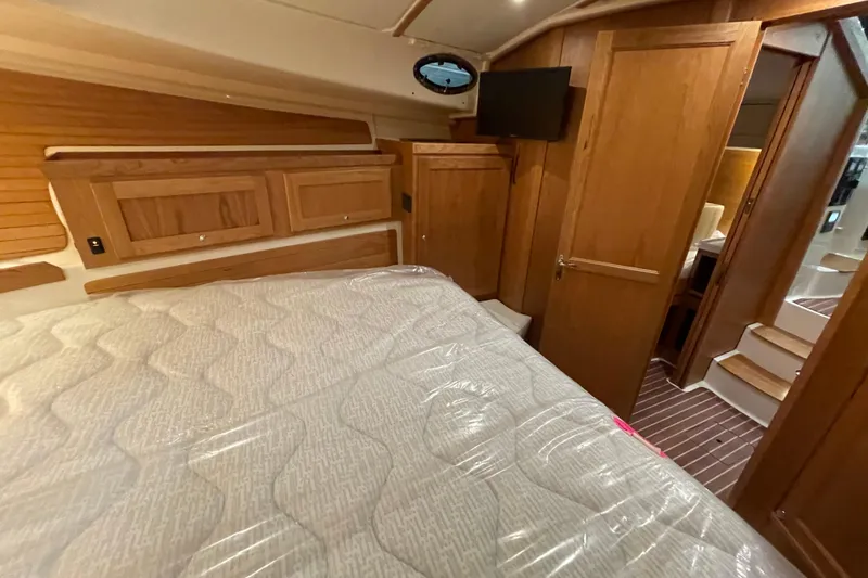Slide: The Image of Luxurious cabin interior of 2026 Back Cove 372 yacht with wood paneling and cozy bedding. - 15