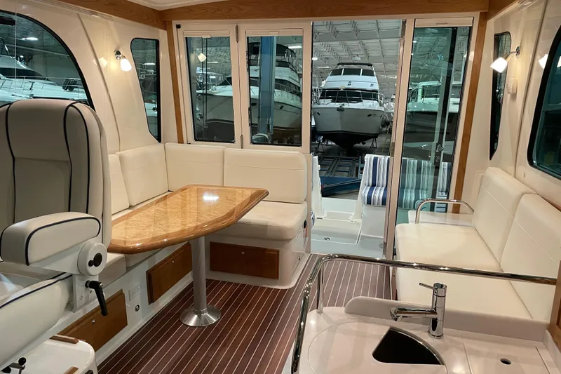 Slide: The Image of Luxurious interior of 2026 Back Cove 372 yacht with elegant seating and wooden accents. - 4