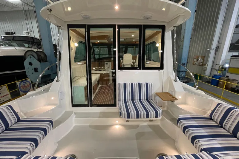 Slide: The Image of 2026 Back Cove 372 yacht interior with striped seating and elegant design. - 7