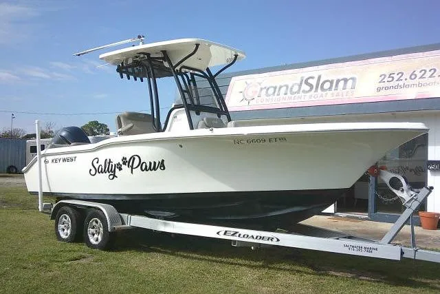 Slide: The Image of 2021 Key West 239 FS boat named "Salty Paws" on trailer at Grand Slam dealership. - 1