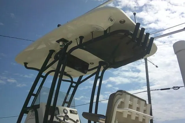 Slide: The Image of 2021 Key West 239 FS boat with T-top and rod holders under a blue sky. - 10