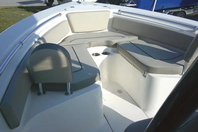 Slide: The Image of 2021 Key West 239 FS boat interior with cushioned seating and cup holders. - 16