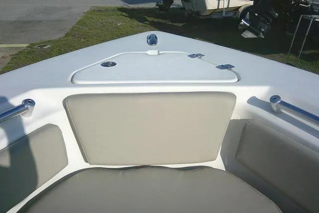 Slide: The Image of 2021 Key West 239 FS boat interior with cushioned seating and storage compartment. - 17