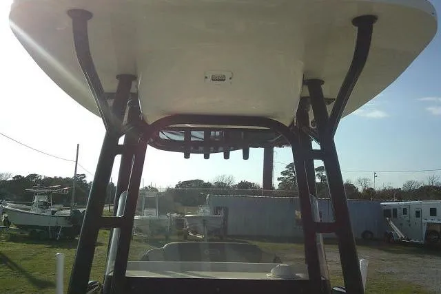 Slide: The Image of 2021 Key West 239 FS boat with T-top, viewed from below, in a yard setting. - 23