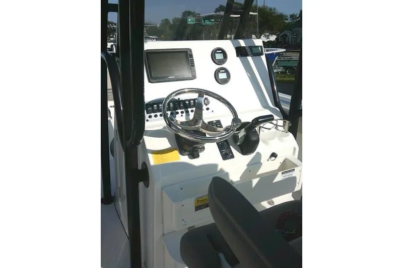 Slide: The Image of 2021 Key West 239 FS boat console with steering wheel and navigation controls. - 27