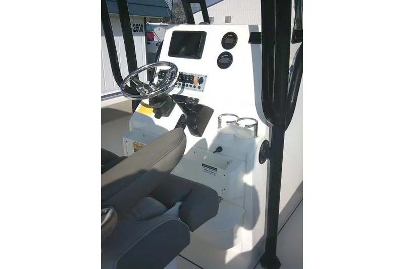 Slide: The Image of 2021 Key West 239 FS boat console with steering wheel and gauges. - 28