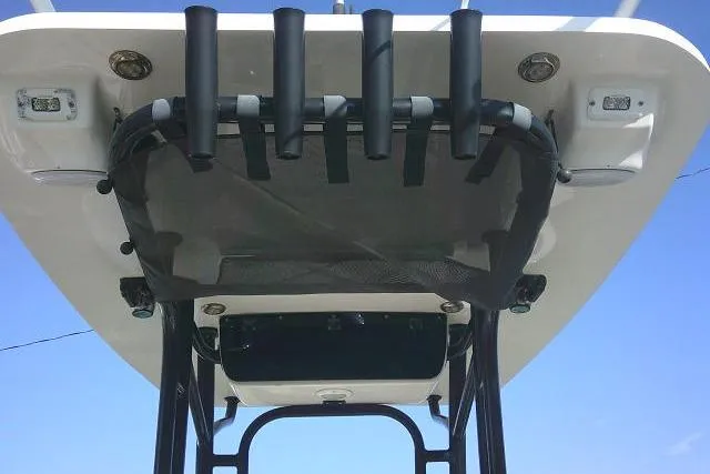 Slide: The Image of 2021 Key West 239 FS boat top view with rod holders against blue sky. - 36