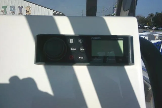 Slide: The Image of Control panel on 2021 Key West 239 FS boat dashboard, featuring a Fusion stereo system. - 37