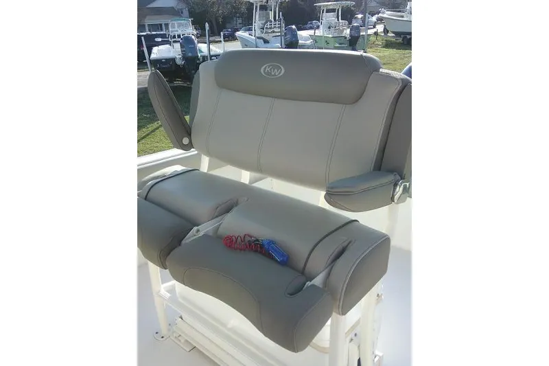 Slide: The Image of 2021 Key West 239 FS boat seat with armrests and key fob on cushion. - 42