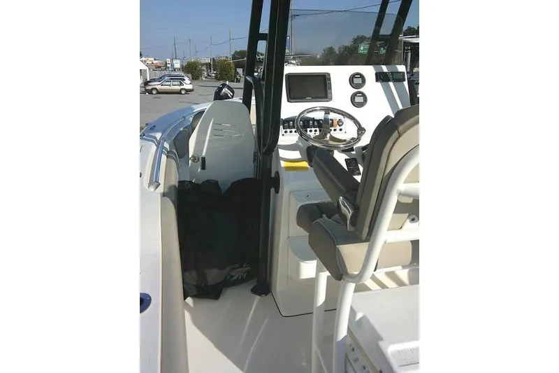 Slide: The Image of 2021 Key West 239 FS boat interior with steering console and seating. - 46