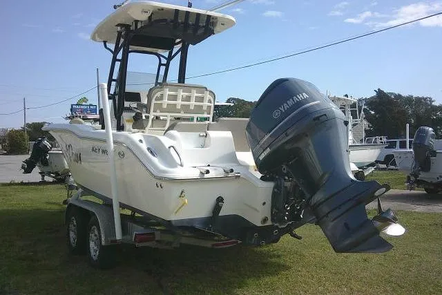 Slide: The Image of 2021 Key West 239 FS boat with Yamaha outboard motor on trailer, parked on grass. - 6