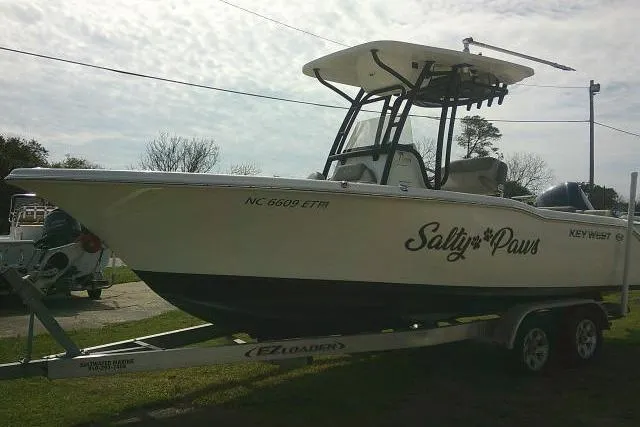 Slide: The Image of 2021 Key West 239 FS boat named "Salty Paws" on a trailer, side view. - 7