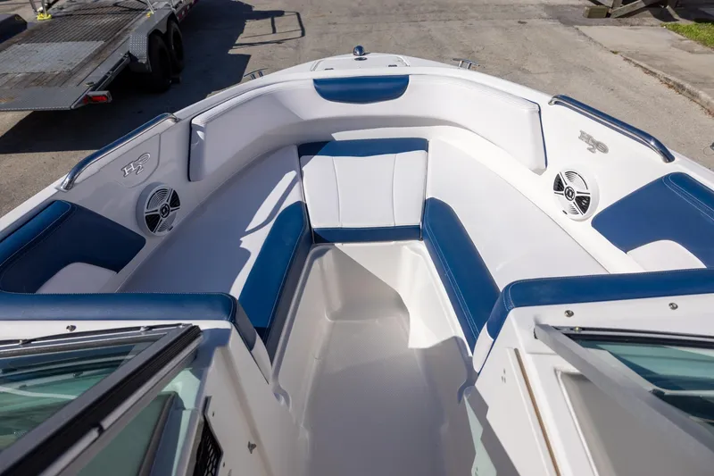 Slide: The Image of 2018 Chaparral 21 H2O Sport OB boat interior with blue and white seating. - 11