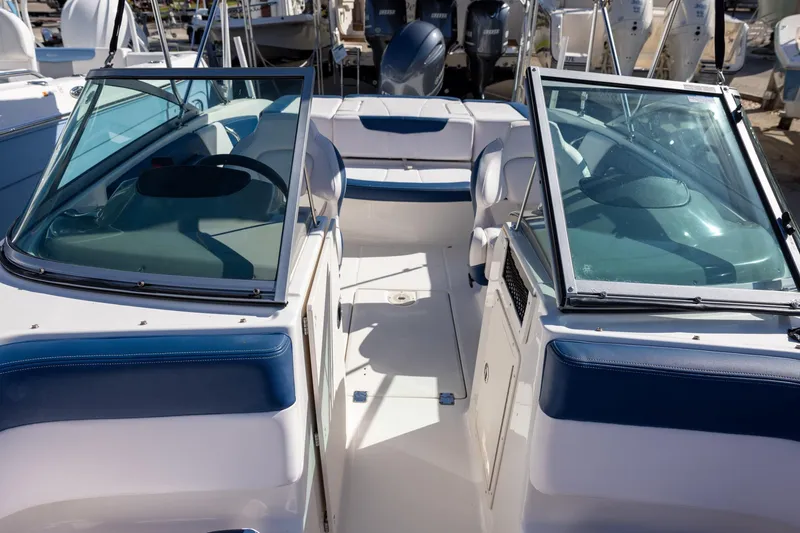 Slide: The Image of 2018 Chaparral 21 H2O Sport OB boat interior with blue and white seating. - 13