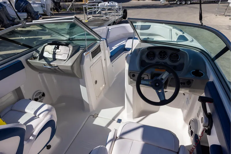Slide: The Image of 2018 Chaparral 21 H2O Sport OB boat interior with steering wheel and seating. - 6