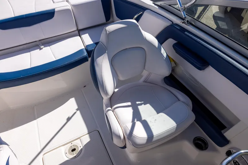 Slide: The Image of 2018 Chaparral 21 H2O Sport OB boat interior with white and blue seating. - 9