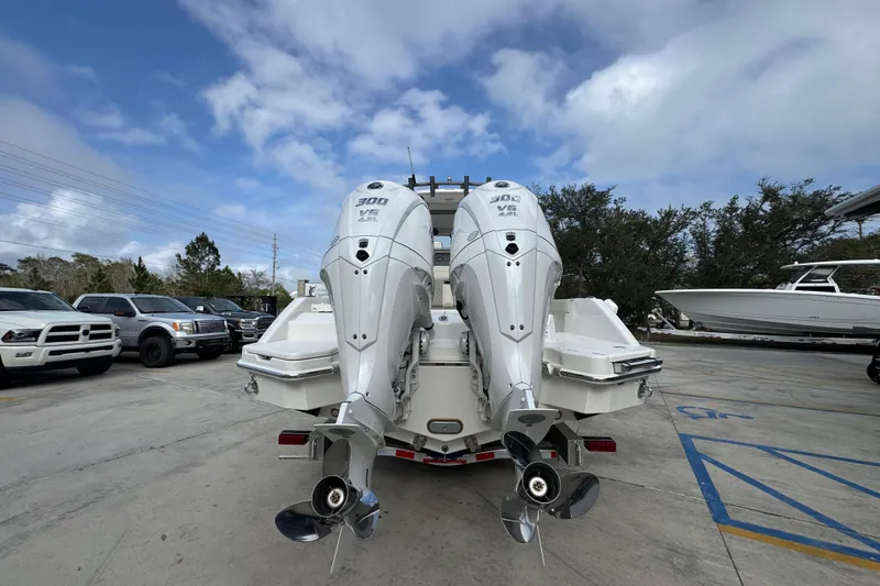Slide: The Image of 2026 Solace 28 HCS boat with dual outboard engines in a parking lot. - 13