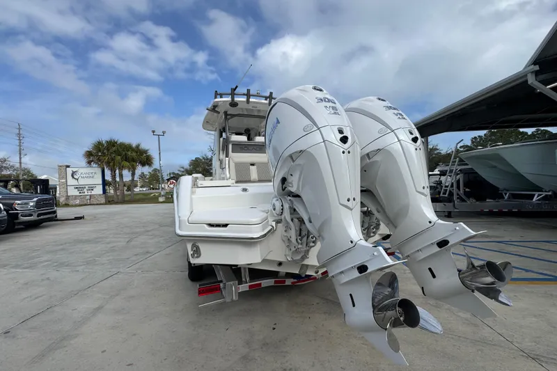 Slide: The Image of 2026 Solace 28 HCS boat with dual outboard engines in a marina setting. - 14
