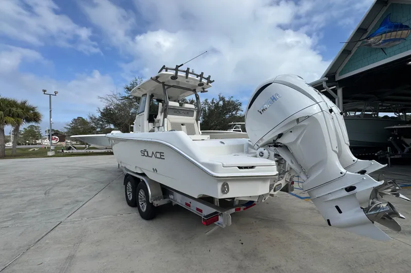 Slide: The Image of 2026 Solace 28 HCS boat with Yamaha engine on trailer, parked outdoors. - 15